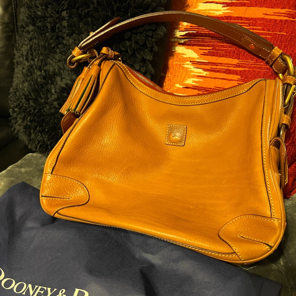 Dooney and Bourke Florentine side pocket hobo in Natural.